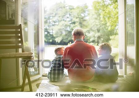Grandfather and grandsons sitting in doorway View Large Photo Image Stock Image - Grandfather and grandsons sitting in doorway. Fotosearch