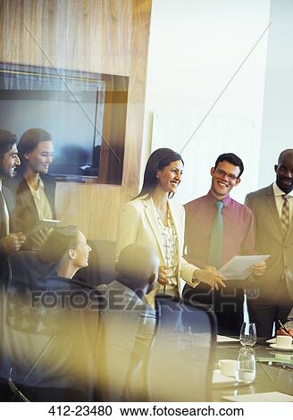 Group of business people smiling and discussing in conference room View Large Photo Image Stock Image - Group of business people smiling and discussing in conference room. Fotosearch
