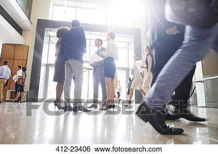 Group of business people standing and talking in office View Large Photo Image Stock Photograph - Group of business people standing and talking in office. Fotosearch