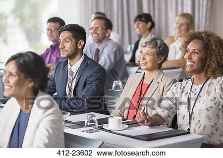 Group of people sitting and listening to speech during seminar View Large Photo Image Stock Image - Group of people sitting and listening to speech during seminar. Fotosearch