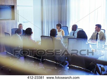 Group of smiling business people attending meeting in conference room View Large Photo Image Stock Image - Group of smiling business people attending meeting in conference room. Fotosearch