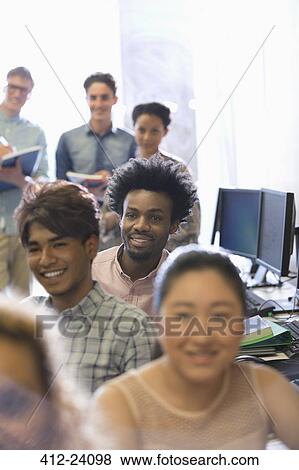 Stock Photo - Group of students during lecture in sunlit classroom. Fotosearch
