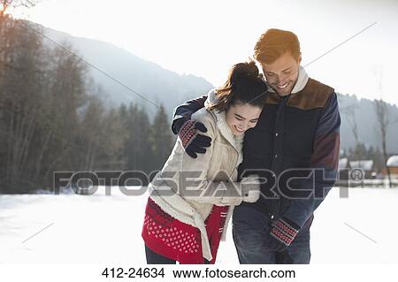 Happy couple walking in snow View Large Photo Image Picture - Happy couple walking in snow. Fotosearch