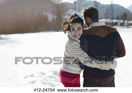 Picture - Happy couple walking in snow. Fotosearch