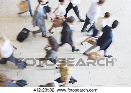 High angle view of business people walking in office on tiled floor View Large Photo Image Stock Image - High angle view of business people walking in office on tiled floor. Fotosearch
