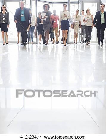 Stock Photo - Large group of business people walking in office. Fotosearch