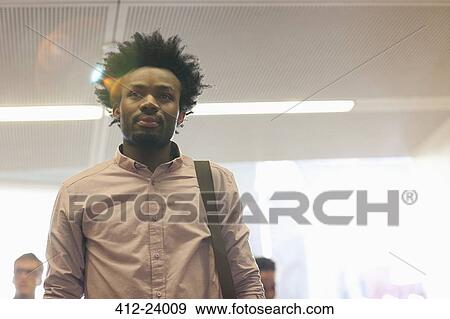 Low-angle view of university student standing in classroom View Large Photo Image Stock Photo - Low-angle view of university student standing in classroom. Fotosearch