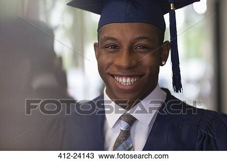 Male student wearing graduation clothes and smiling at camera View Large Photo Image Stock Image - Male student wearing graduation clothes and smiling at camera. Fotosearch