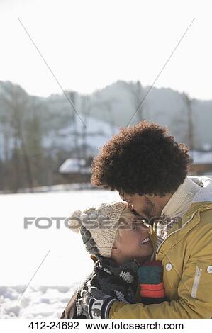 Man kissing woman's forehead in snow View Large Photo Image Stock Image - Man kissing woman's forehead in snow. Fotosearch