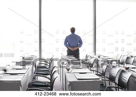 Mature businessman looking out of office window View Large Photo Image Stock Photo - Mature businessman looking out of office window. Fotosearch
