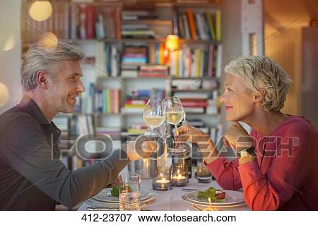 Older couple toasting each other at romantic dinner View Large Photo Image Stock Photo - Older couple toasting each other at romantic dinner. Fotosearch