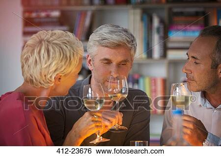 Older friends tasting white wine View Large Photo Image Stock Photograph - Older friends tasting white wine. Fotosearch