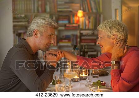 Older man kissing hand of wife at romantic dinner View Large Photo Image Stock Photo - Older man kissing hand of wife at romantic dinner. Fotosearch