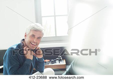 Older man listening to turntable with headphones View Large Photo Image Stock Photo - Older man listening to turntable with headphones. Fotosearch
