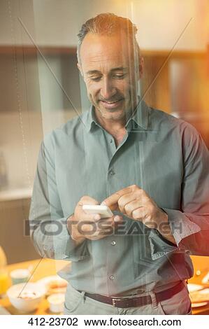 Older man texting on cell phone View Large Photo Image Stock Image - Older man texting on cell phone. Fotosearch