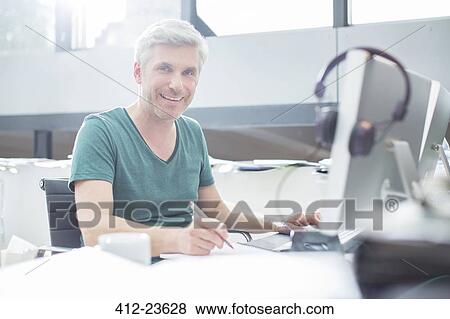 Older man working on computer at desk View Large Photo Image Stock Photo - Older man working on computer at desk. Fotosearch