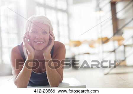 Older woman relaxing on floor View Large Photo Image Stock Photography - Older woman relaxing on floor. Fotosearch
