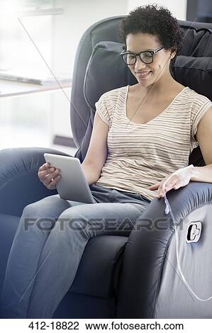 Patient reading on digital tablet, undergoing medical treatment in outpatient clinic View Large Photo Image Stock Image - Patient reading on digital tablet, undergoing medical treatment in outpatient clinic. Fotosearch