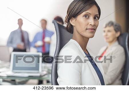 Portrait of beautiful businesswoman sitting in office View Large Photo Image Stock Photograph - Portrait of beautiful businesswoman sitting in office. Fotosearch