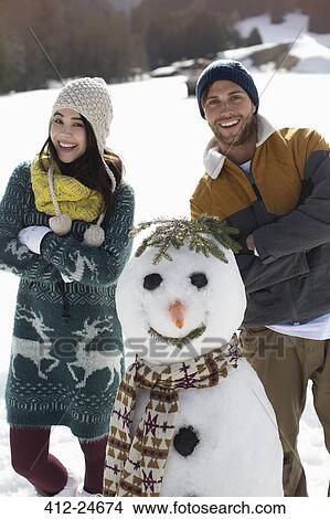 Picture - Portrait of couple with snowman. Fotosearch