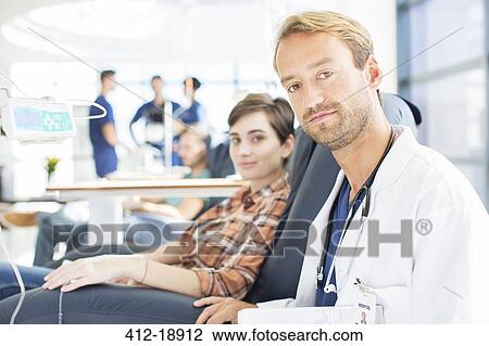 Portrait of doctor and patient undergoing medical treatment in outpatient clinic View Large Photo Image Stock Image - Portrait of doctor and patient undergoing medical treatment in outpatient clinic. Fotosearch
