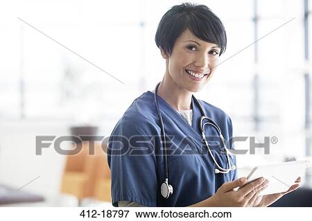 Portrait of female doctor with stethoscope around neck, holding digital tablet View Large Photo Image Stock Photo - Portrait of female doctor with stethoscope around neck, holding digital tablet. Fotosearch