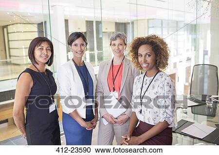 Portrait of four women standing in conference room View Large Photo Image Stock Image - Portrait of four women standing in conference room. Fotosearch