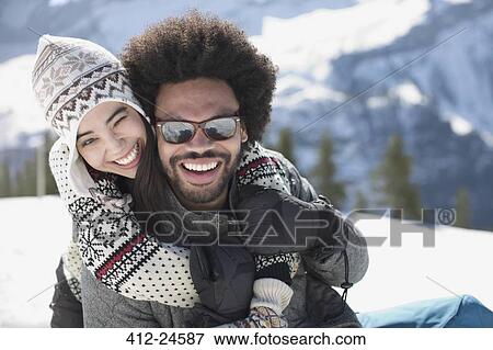 Portrait of happy couple hugging in snow View Large Photo Image Stock Photo - Portrait of happy couple hugging in snow. Fotosearch