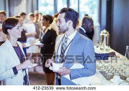Portrait of man and woman talking in lobby of conference center during coffee break View Large Photo Image Stock Photo - Portrait of man and woman talking in lobby of conference center during coffee break. Fotosearch