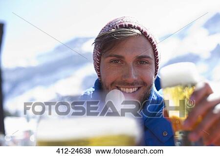 Stock Photo - Portrait of man drinking beer outdoors. Fotosearch