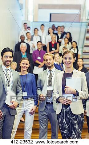 Portrait of men and women standing in lobby of conference center View Large Photo Image Stock Image - Portrait of men and women standing in lobby of conference center. Fotosearch