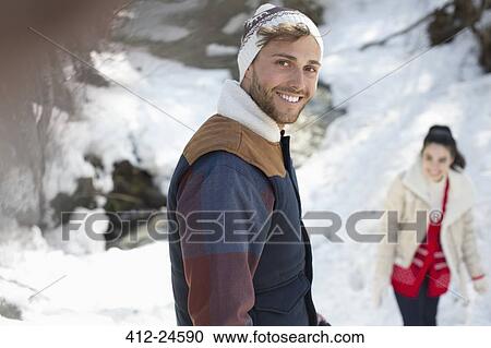 Portrait of smiling couple in snow View Large Photo Image Stock Image - Portrait of smiling couple in snow. Fotosearch