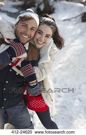Portrait of smiling couple in snow View Large Photo Image Stock Image - Portrait of smiling couple in snow. Fotosearch