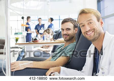 Portrait of smiling doctor and patient undergoing medical treatment in outpatient clinic View Large Photo Image Stock Image - Portrait of smiling doctor and patient undergoing medical treatment in outpatient clinic. Fotosearch