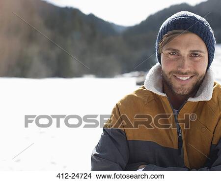 Picture - Portrait of smiling man in snow. Fotosearch