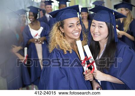 Portrait of smiling students with diplomas standing in corridor View Large Photo Image Stock Photography - Portrait of smiling students with diplomas standing in corridor. Fotosearch