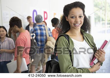 Portrait of smiling university student standing in corridor View Large Photo Image Stock Image - Portrait of smiling university student standing in corridor. Fotosearch