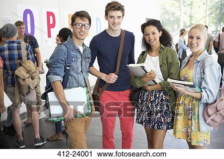 Portrait of smiling university students standing beside university View Large Photo Image Stock Image - Portrait of smiling university students standing beside university. Fotosearch