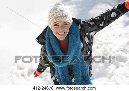 Stock Photo - Portrait of smiling woman in snow. Fotosearch