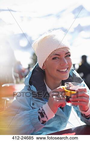 Portrait of smiling woman in warm clothing drinking tea View Large Photo Image Stock Photography - Portrait of smiling woman in warm clothing drinking tea. Fotosearch