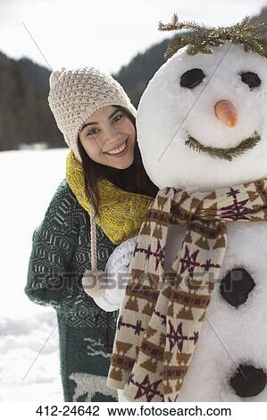 Portrait of smiling woman with snowman View Large Photo Image Stock Image - Portrait of smiling woman with snowman. Fotosearch