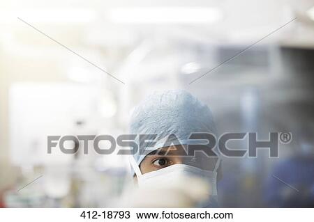 Portrait of surgeon wearing surgical cap and mask View Large Photo Image Stock Image - Portrait of surgeon wearing surgical cap and mask. Fotosearch