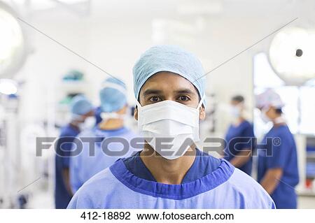 Portrait of surgeon wearing surgical cap, mask and gown in operating theater View Large Photo Image Stock Image - Portrait of surgeon wearing surgical cap, mask and gown in operating theater. Fotosearch
