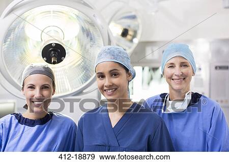 Stock Photo - Portrait of three female surgeons in operating theater. Fotosearch