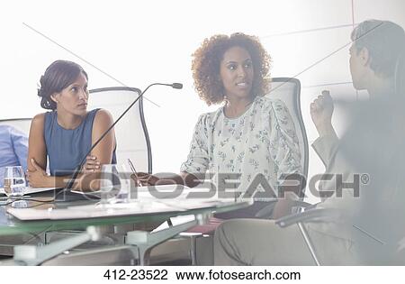 Portrait of three women having discussion at conference table View Large Photo Image Stock Image - Portrait of three women having discussion at conference table. Fotosearch