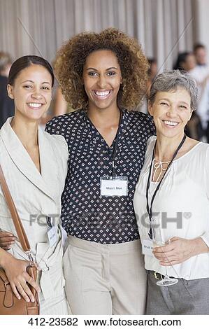 Portrait of three women smiling to camera during meeting break View Large Photo Image Stock Image - Portrait of three women smiling to camera during meeting break. Fotosearch