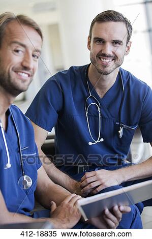 Portrait of two doctors with stethoscopes around necks in hospital View Large Photo Image Stock Photography - Portrait of two doctors with stethoscopes around necks in hospital. Fotosearch