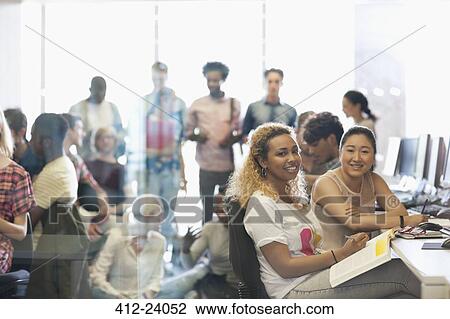 Portrait of two female university students sitting at desk in technology classroom View Large Photo Image Stock Image - Portrait of two female university students sitting at desk in technology classroom. Fotosearch