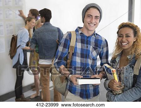 Portrait of two smiling university students standing in corridor View Large Photo Image Stock Photo - Portrait of two smiling university students standing in corridor. Fotosearch
