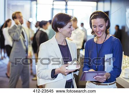 Portrait of two smiling women, talking in lobby of conference center during coffee break View Large Photo Image Stock Photography - Portrait of two smiling women, talking in lobby of conference center during coffee break. Fotosearch